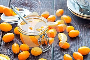 Close Up View of Kumquat Jam in Glass Jar on Dark Wooden Table