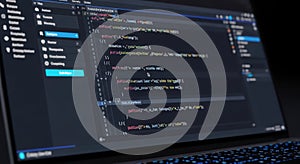 Programming Code on Laptop Screen in Dark Environment