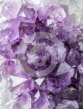 Close up view of large violet amethyst crystal cluster. Esoteric magical background concept.