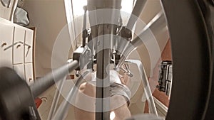 Close up view on legs of man exercising on crosstrainer machine