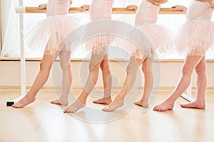 Close up view. Little ballerinas preparing for performance by practicing dance moves