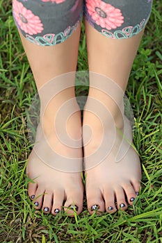 Close-up view of little shoeless girl toes on feet