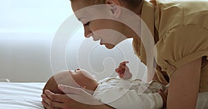 Close up view loving mother kissing cute newborn