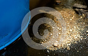 Sprinkle sand for adsorbent on Hydraulic oil leak in base tray. photo