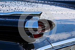 Close up view of luxury vintage car tail lamp with rain drops