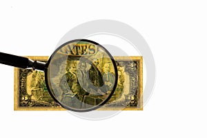 Close up view of magnifying glass over two dollar bill. Banknote.