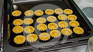 Close up view of making process egg tart in a mold on a black tray