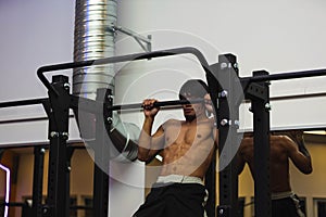 Close up view of a male doing pull-ups. Healthy lifestyle concept