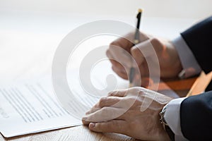 Close up view of male hand signing business contract concept