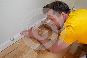 view on male hands fitting skirting board