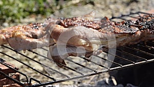 Close up view of man hands cooking roast beef meat. Outdoors barbecue