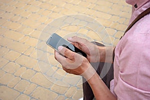 Close up view of man hands using smartphone.