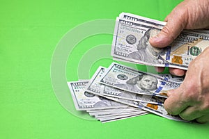Close up view of man`s hands counting dollar banknotes on chrome key background