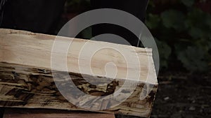 Close up view of man`s hands working a wooden table