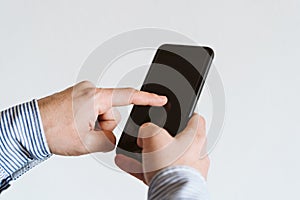 close up view of a man using mobile phone indoors. Technology concept