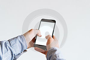 close up view of a man using mobile phone indoors. Technology concept