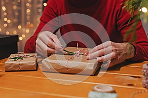 Close-up view of man wrapping Christmas present