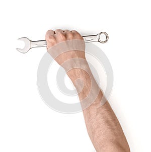 Close up view of a man's hand holding combination wrench isolated on white background