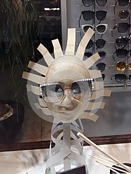 Close up view of mannequin with various fashionable sunglass in shop