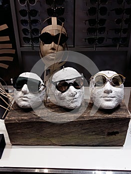 Close up view of mannequins with various fashionable sunglasses in shop