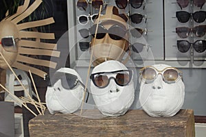 Close up view of mannequins with various fashionable sunglasses in shop