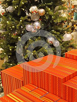 close-up view of many large colorful gifts in front of the christmas tree