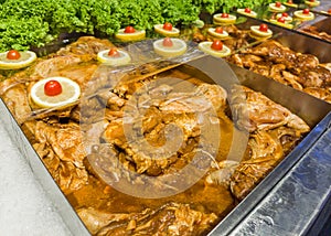 Close-up view of the marinated meat on the ais selling in the supermarket