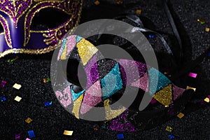 Close-up view of Masquerade mask with confetties on black background photo