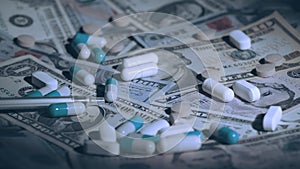 Close up view of medical pills falling on dollar banknotes. Rising cost of healthcare. Multicolored pills on money