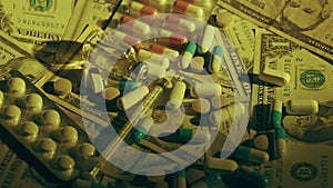 Close up view of medical pills rotating on the dollar banknotes. Rising cost of healthcare. Coronavirus outbreak
