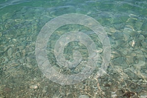 close-up view of the Mediterranean sea with large pebbles on the