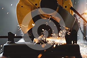 Close-up view of metalworking on angular grinding machine in workshop. Sparks fly apart. Work in process