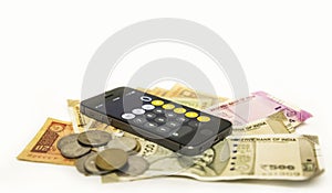 Close up view of Mobile Phone Calculate and new Indian rupees and coin