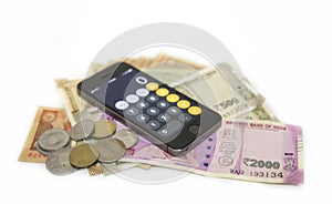 Close up view of Mobile Phone Calculate and new Indian rupees and coins background.