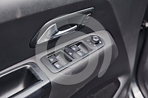 Close up view of modern automobile`s door. Buttons and knobs