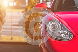 Close-up view of modern red sport car lamp headlight. Selective focus with blurred background for copy space