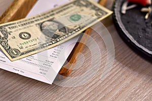 Close-up view, Money tip for service in the restaurant, Money dollar on wooden plate. photo