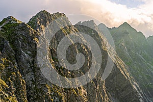 Close up view at mountain peaks under clouds. Summer afternoon, Tatra Mountains, Orla Perc