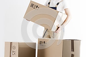 Close-up view of mover holding cardboard box isolated on white background. Concept o relocation into new house. Loader with boxes.