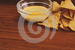 Close up view of nachos with cheese dip