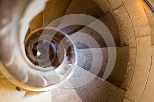 Close up view at narrow stone spiral stairway