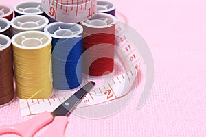 Close up view, needle, scissor, thread, tailor Meter, at Pink Background