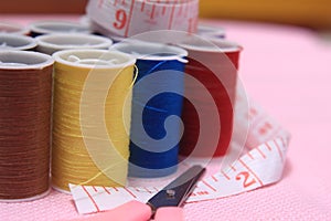 Close up view, needle, scissor, thread, tailor Meter, at Pink Background