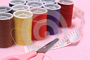 Close up view, needle, scissor, thread, tailor Meter, at Pink Background