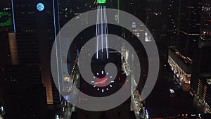 Close-up view of neon illuminated spike and clock on top of Mercantile National Bank Building. Aerial drone night view