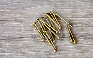 Close up view of new brass nails, some brass nails on a wood