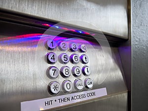 Close up view of a number pin pad for inputting an access code for a high rise building