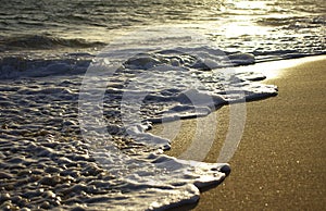 Close up view of an ocean tide at the sunset beach