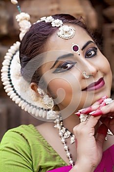 Close up view of odissi dancer wearing traditional costume. Culture and traditions of India.