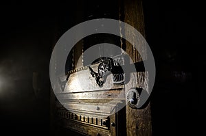 Close up view of old antique wooden door inside dark room. Selective focus